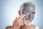 Elderly man, skin and face mask in studio for health, wellness and organic cleaning with smile by background. Senior model, hand or natural charcoal product for facial cosmetics for dermatology detox
