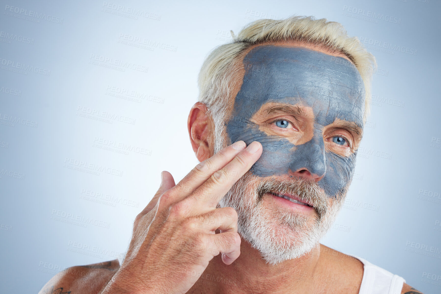 Buy stock photo Elderly man, skin and face mask in studio for health, wellness and organic cleaning with smile by background. Senior model, hand or natural charcoal product for facial cosmetics for dermatology detox