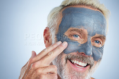 Buy stock photo Senior man, skin and face mask in studio for health, wellness and organic cleaning with smile by background. Elderly male, hand and natural charcoal product for facial cosmetics for dermatology detox
