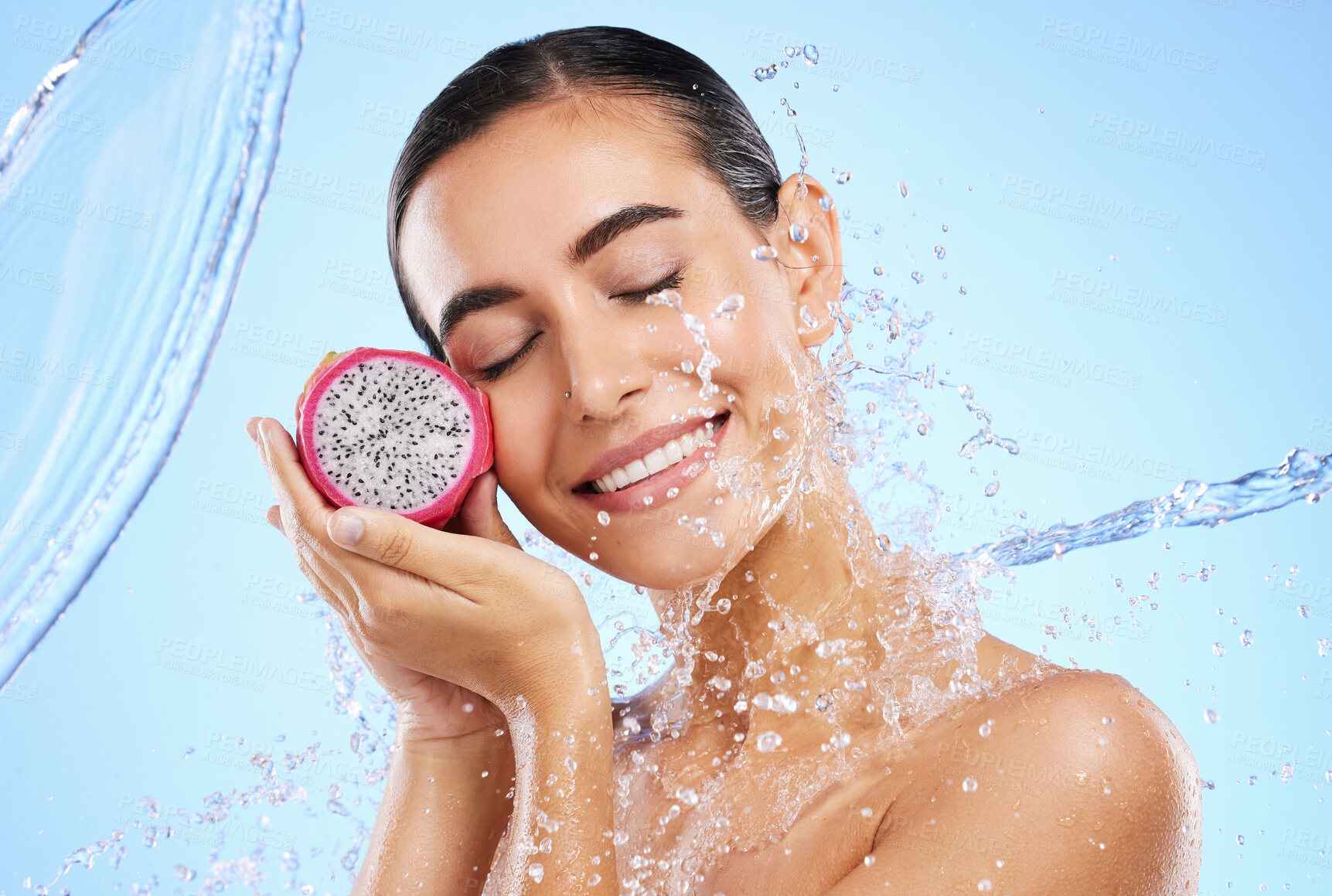 Buy stock photo Dragon fruit, water or happy woman with beauty in studio on blue background for healthcare or vegan diet. Smile, wellness or healthy girl model face with fruits or vitamin c for skincare or detox 