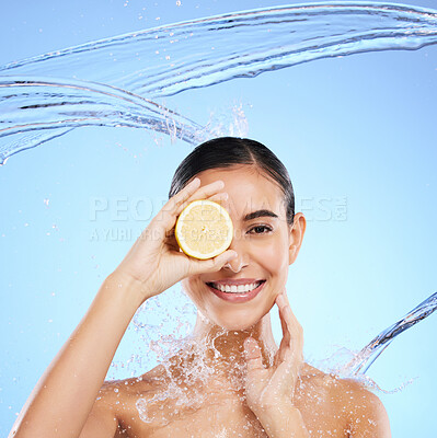 Buy stock photo Shower, lemon and water splash with portrait of woman in studio for natural cosmetics, nutrition and detox. Glow, fruits and hydration with female on blue background for vitamin c, face and skincare