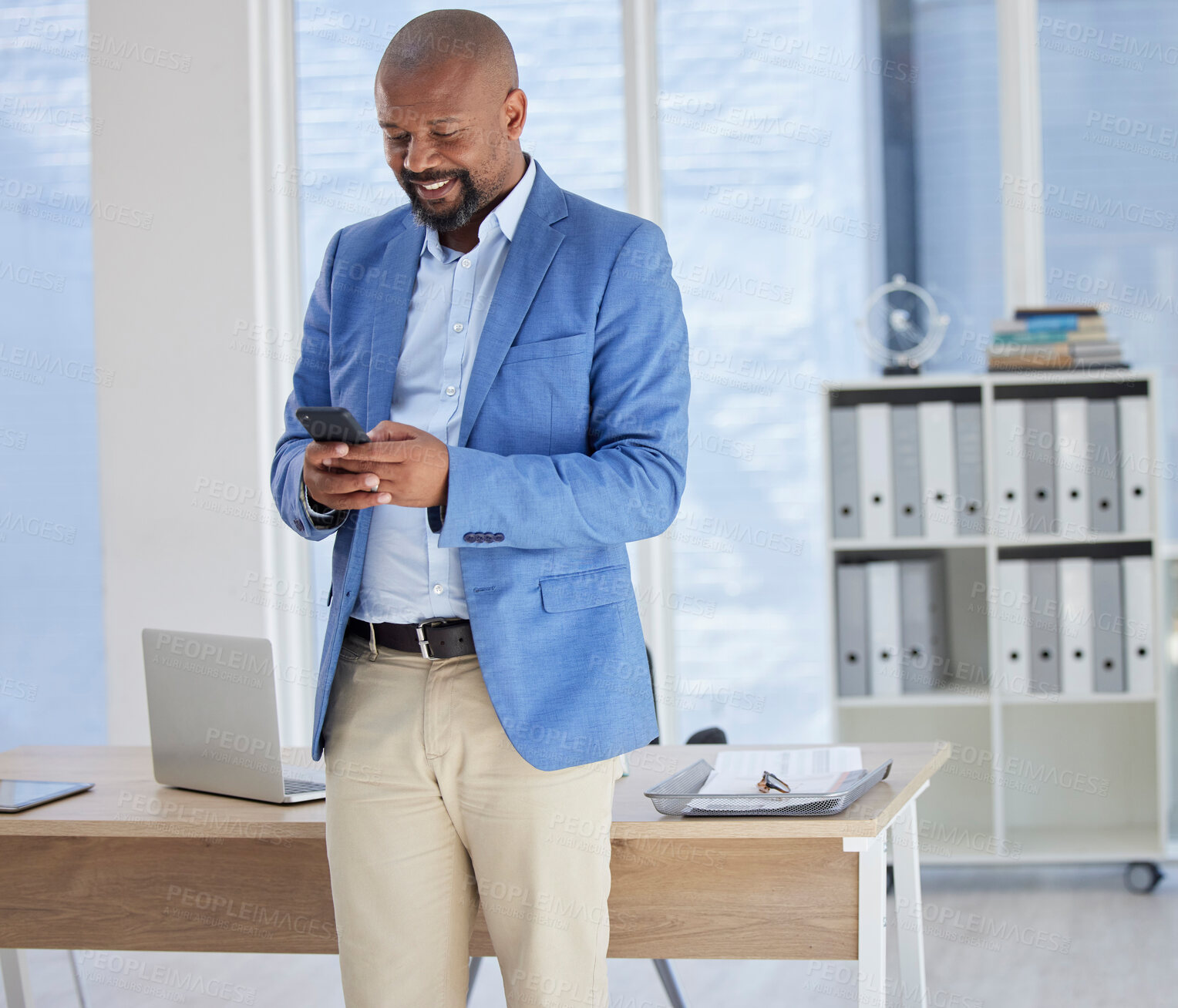 Buy stock photo Happy black man, phone or text in business office for financial deal research, banking app or investment management. Smile, corporate or businessperson on mobile technology for reading finance report