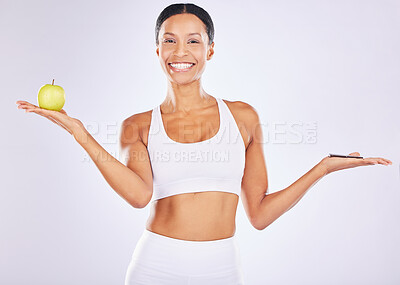 Buy stock photo Portrait, apple or happy woman with chocolate choice in studio for a healthy snack, diet nutrition or junk food. Body decision, lose weight or girl fitness model with fruits, candy or sweets options