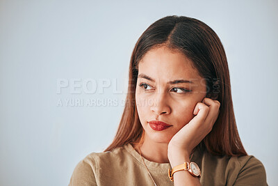 Buy stock photo Serious woman, thinking and space for idea in studio with advertising or product placement. Face of female on white background with doubt, planning or contemplating problem, plan or decision