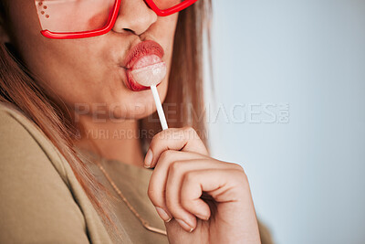Buy stock photo Lollipop, woman closeup and mouth with makeup, cosmetics and gen z style eating a sweet candy. Lips, young person and studio background with mockup and female model with sweets and fashion aesthetic