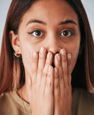 Buy stock photo Portrait, woman closeup and surprise in a studio with a female cover mouth from shock. Isolated, grey background and hands on a face of a young person model with wow, worry and alert reaction