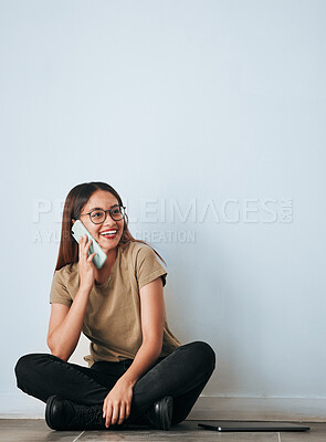 Buy stock photo Phone call, floor and happy woman talking in home by wall background with mockup. Cellphone, thinking and person smile while sitting on ground, discussion or conversation, chatting or speaking online