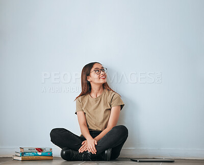 Buy stock photo Textbook thinking, student woman and smile by a wall with school notes for learning with happiness. University, college and house with floor sitting of a happy person ready for studying with mockup