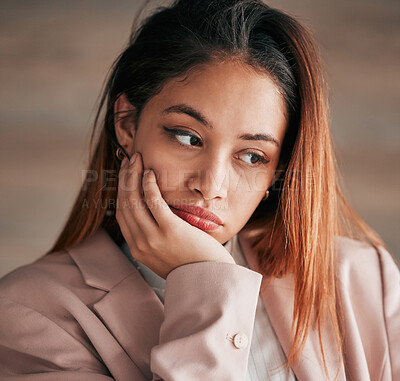 Buy stock photo Face, thinking and depression with a woman feeling or looking sad and alone on a blurred background. Mental health, down and lonely with an unhappy or miserable young female sitting hand on chin