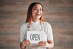 Cafe, portrait and woman holding an open sign in studio on a blurred background, Coffee shop, small business startup and management with a young female entrepreneur indoor to display advertising