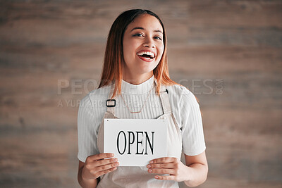 Buy stock photo Cafe, portrait and woman holding an open sign in studio on a blurred background. Coffee shop, small business startup and management with a young female entrepreneur indoor to display advertising