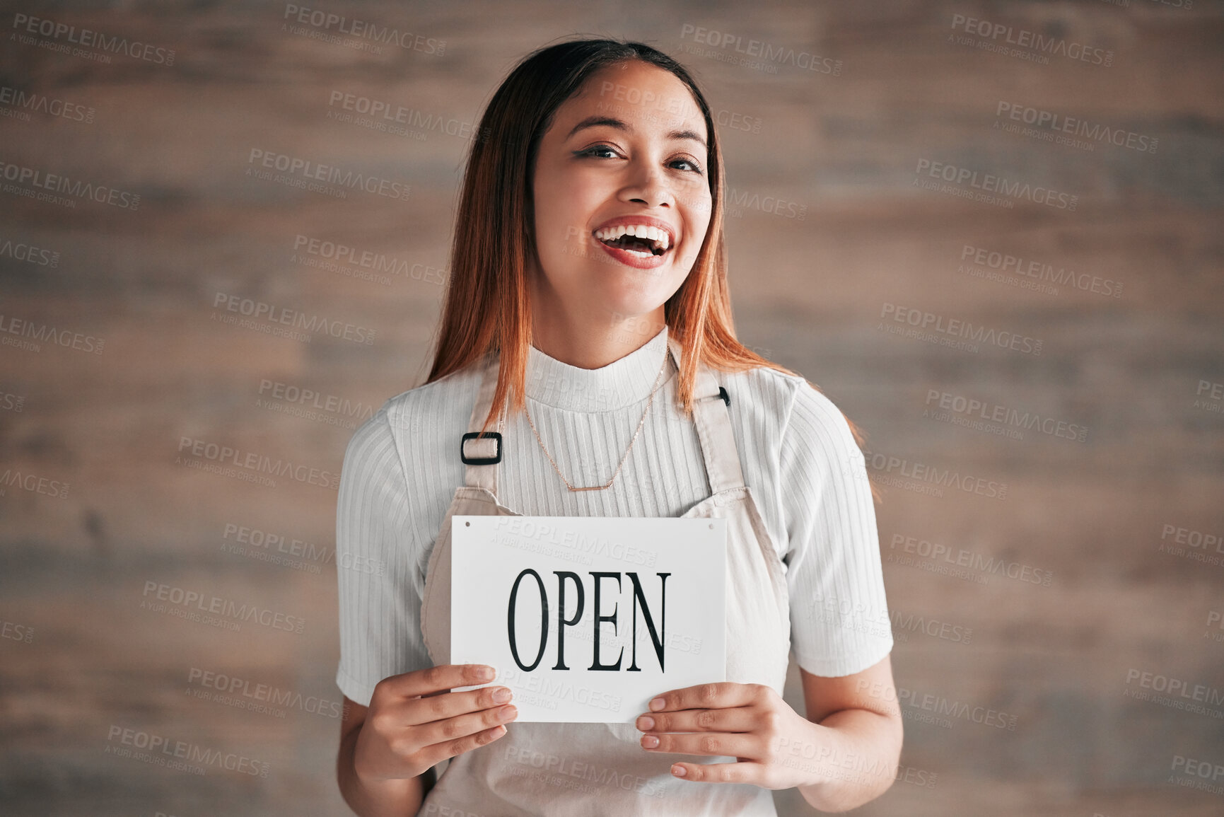 Buy stock photo Cafe, portrait and woman holding an open sign in studio on a blurred background. Coffee shop, small business startup and management with a young female entrepreneur indoor to display advertising