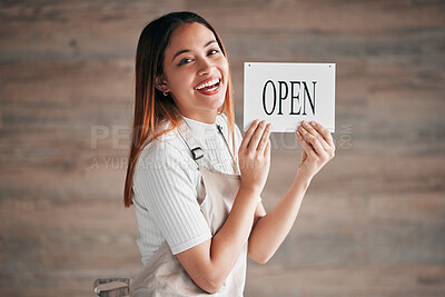 Buy stock photo Coffee shop, portrait and woman holding an open sign in studio on a blurred background for hospitality. Cafe, startup and management with a female owner or entrepreneur indoor to display advertising