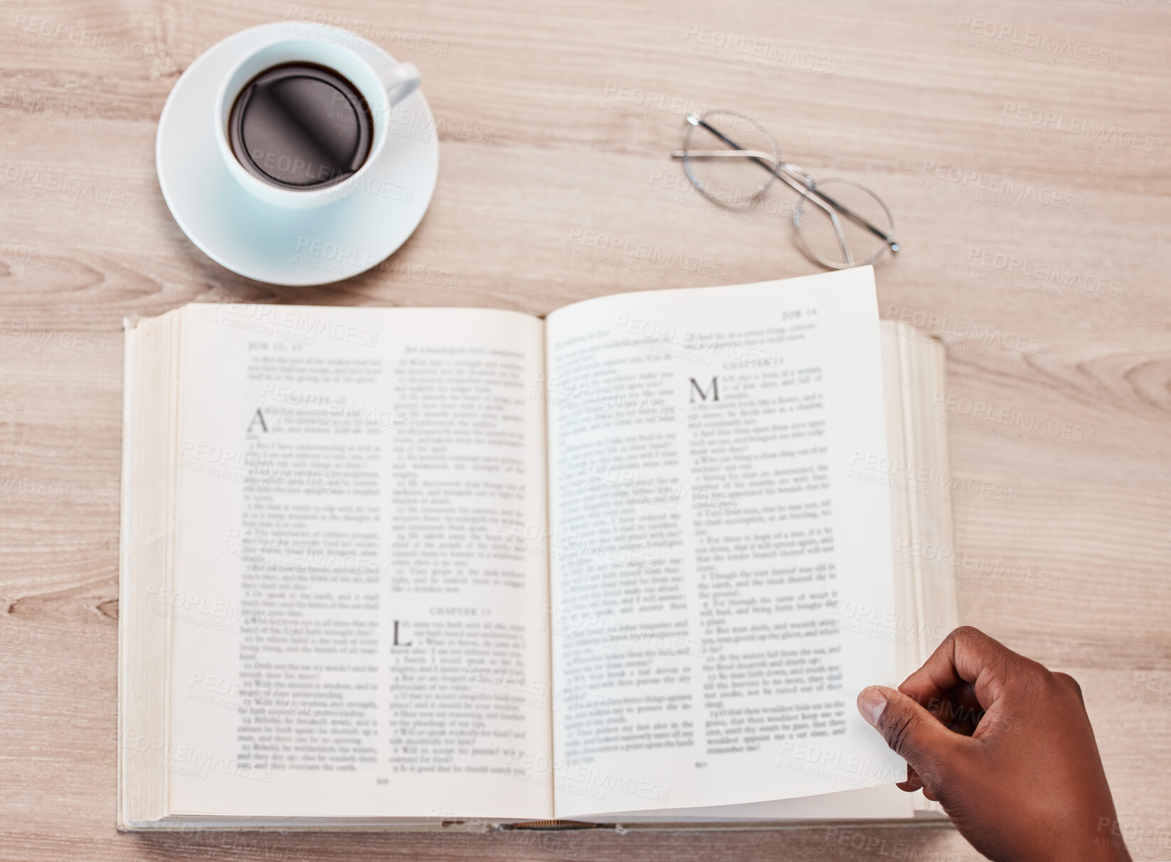 Buy stock photo Hand, bible and a person reading in a coffee shop for religion, belief or faith in god and jesus. Education, learning and overhead with an adult in a cafe to study for spiritual knowledge in christ