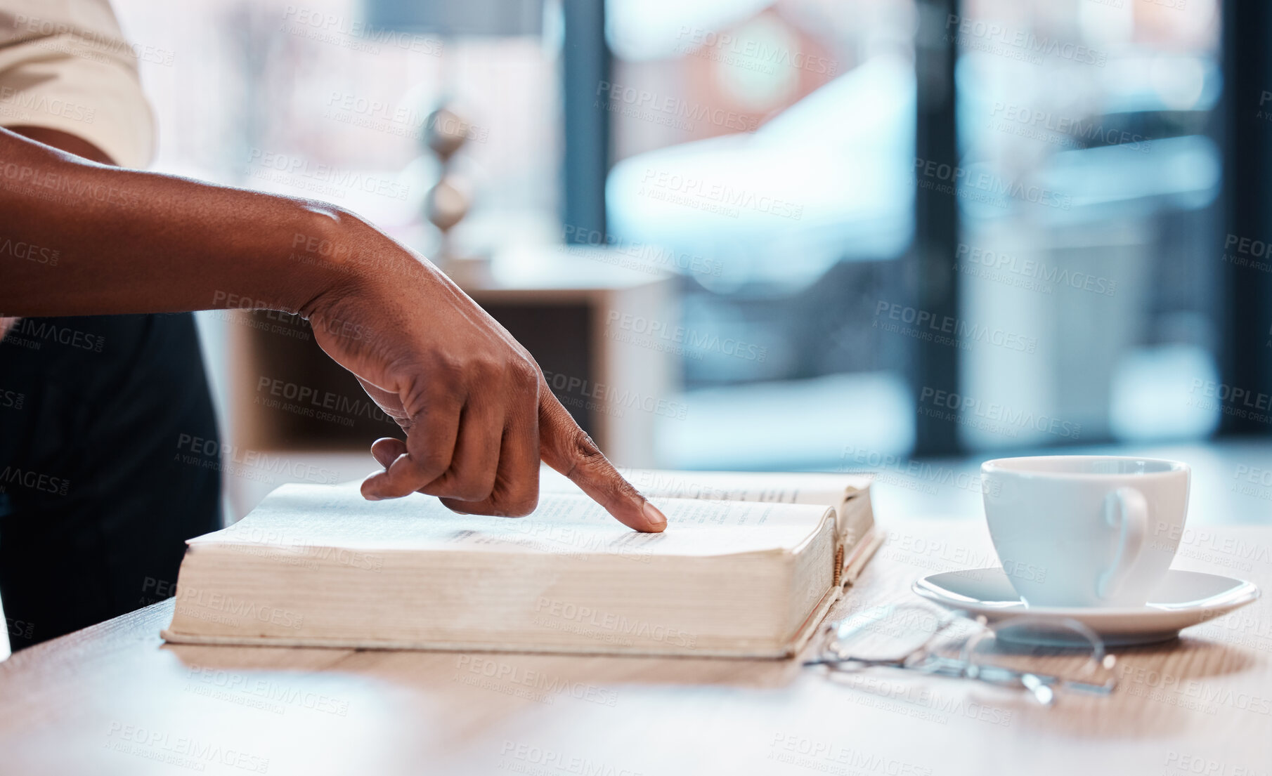 Buy stock photo Hand, bible and a person reading in a cafe for religion, belief or faith in god and jesus. Education, learning and pointing with an adult in a coffee shop to study for spiritual knowledge in christ