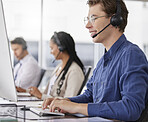 Man, call center and typing on computer, smile in office and working on customer service in workplace. Telemarketing, desktop and happiness of person, male sales agent or consultant consulting online