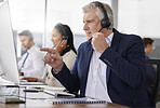 Man, call center and pointing to computer in office while working on customer service in workplace. Telemarketing, focus and mature person, male sales agent or consultant talking or consulting online