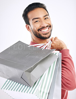 Buy stock photo Portrait, retail and Asian man with shopping bags, smile and discount isolated against a white studio background. Face, Japanese male shopper and customer with parcels, package and purchase with joy 