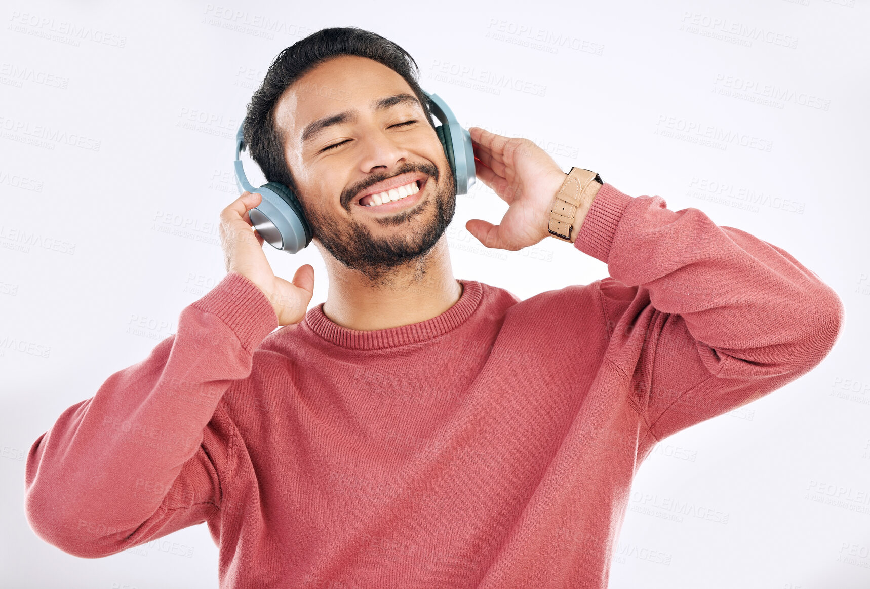 Buy stock photo Headphones, moving and man doing a dance in studio to music, playlist or album for entertainment. Happiness, smile and Asian male model dancing to the radio or listening to a song by white background