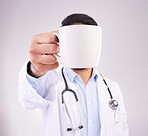 Hand, coffee and doctor in studio for break, relax and morning routine against grey background. Healthcare, tea and man with drink, beverage and cup while working at hospital or clinic isolated