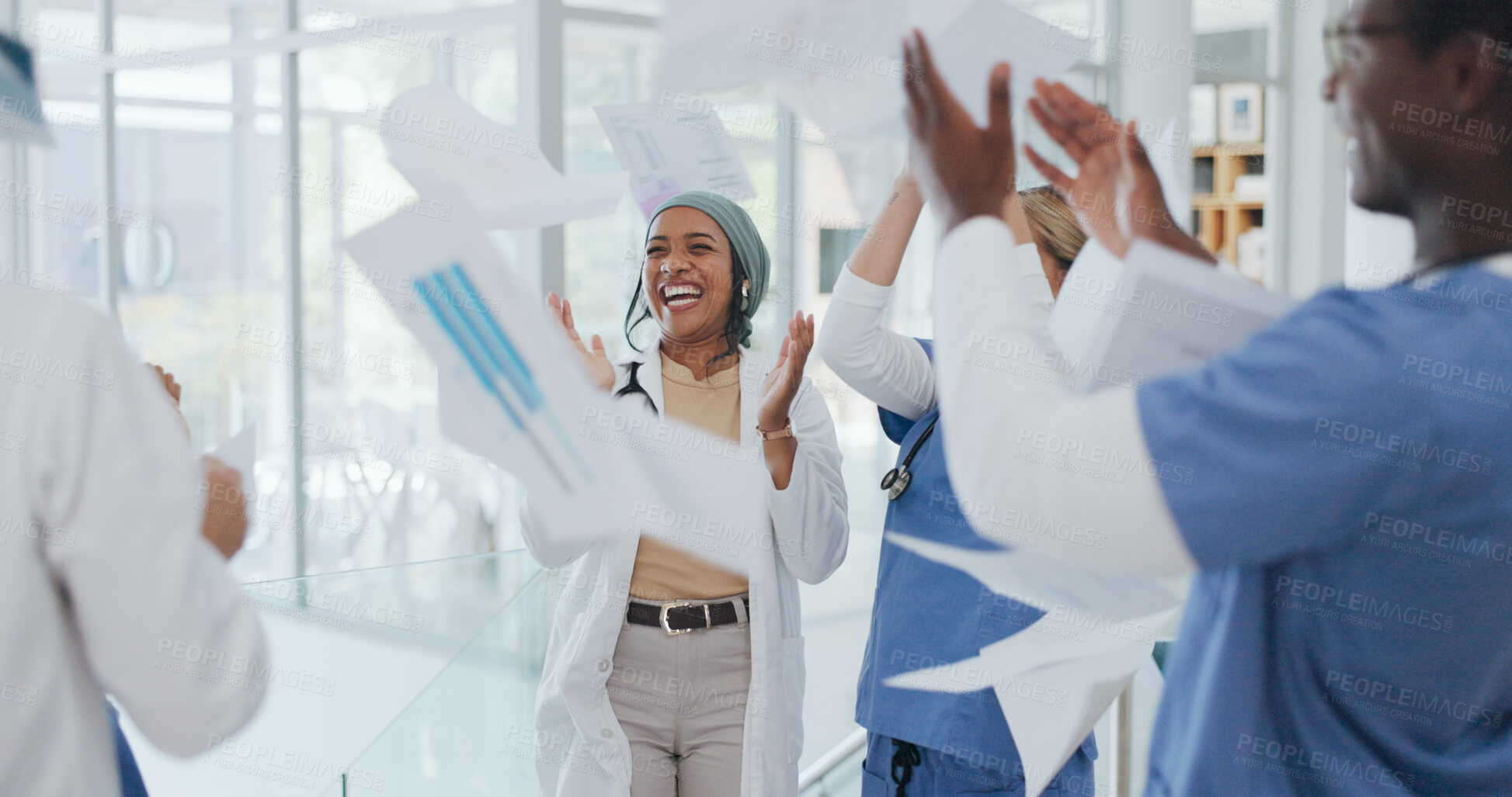 Buy stock photo Doctors, team and throw paper in hospital for success, win and celebration with solidarity, support or diversity. Men, women and applause for confetti, goals and medical results with smile in clinic