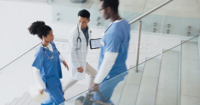 Buy stock photo Doctors, teamwork and people with tablet in hospital, discussion and planning for surgery, health services and wellness. Medic, nurse and clinic staff on stairs with consulting, nurse or advice