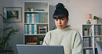 Business woman, typing on laptop and doing research while writing an email or article and sitting in a modern office. Serious, creative entrepreneur using technology for computer communication