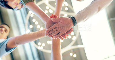 Buy stock photo Business people, hands together and teamwork in support, trust or unity below for motivation at office. Low angle of employee group piling in circle or huddle for team building or collaboration