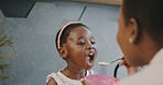 Mother, child and breakfast with mom feeding girl food for nutrition, growth health and wellness in home kitchen. Black woman with girl at family house for quality time, love and eating healthy