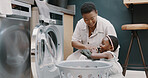 Laundry, mother and child helping with folding of clothes together in a house. Happy, excited and young girl giving help to her mom while cleaning clothing from a washing machine in their home