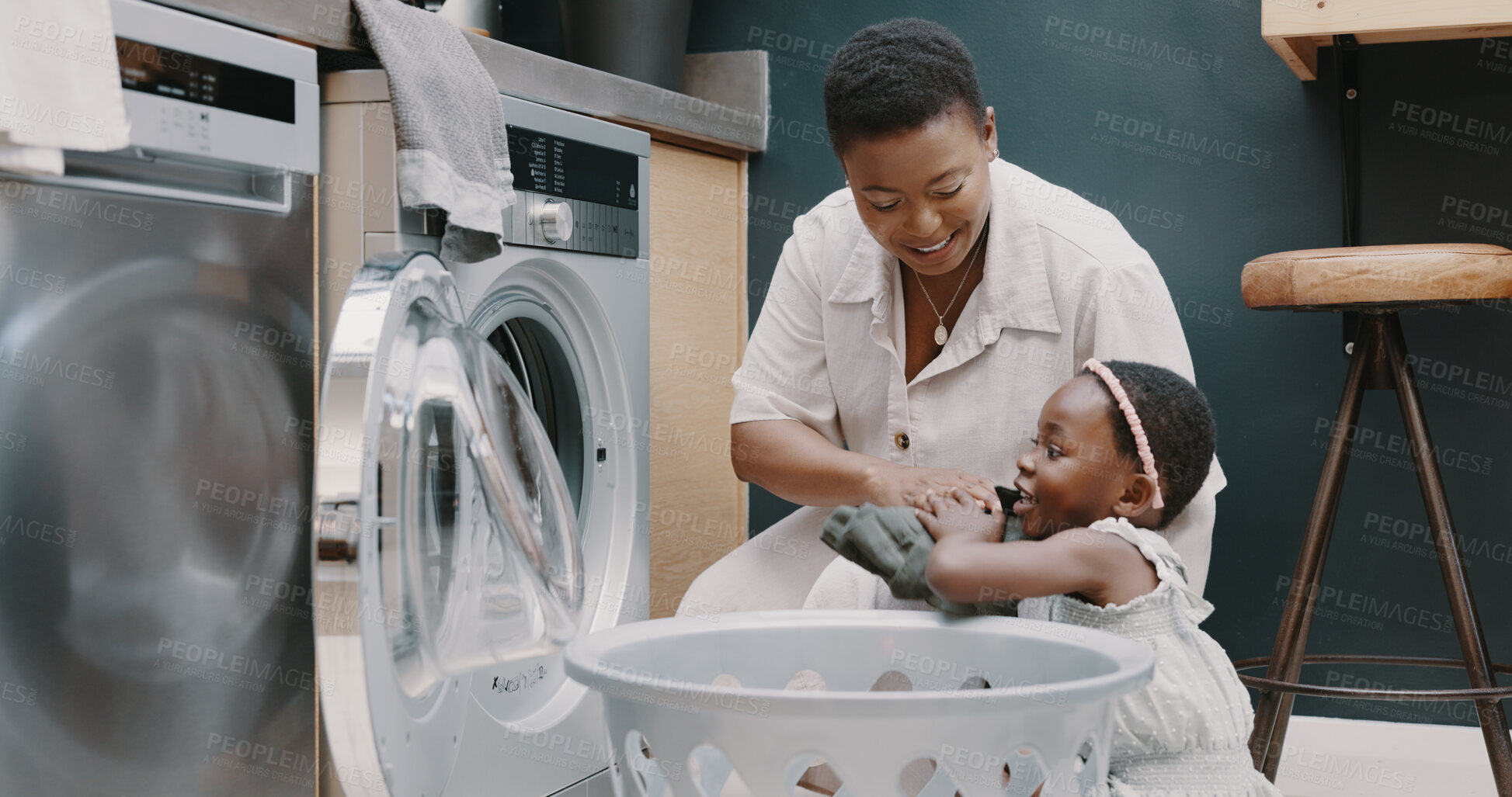 Buy stock photo Laundry, washing machine and a black mother teaching her child about hygiene or chores in the home. Family, cleaning and housework with a young girl learning about housekeeping from a woman parent