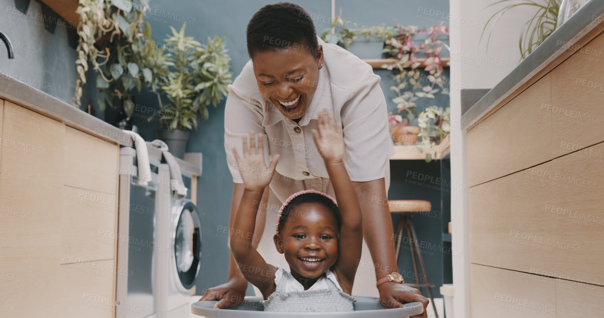 Buy stock photo Woman, kid and together for bond in home with chores, play or game with laundry. Black, mother and daughter with happiness for quality, time and enjoyment by smiling, laughing and love with basket