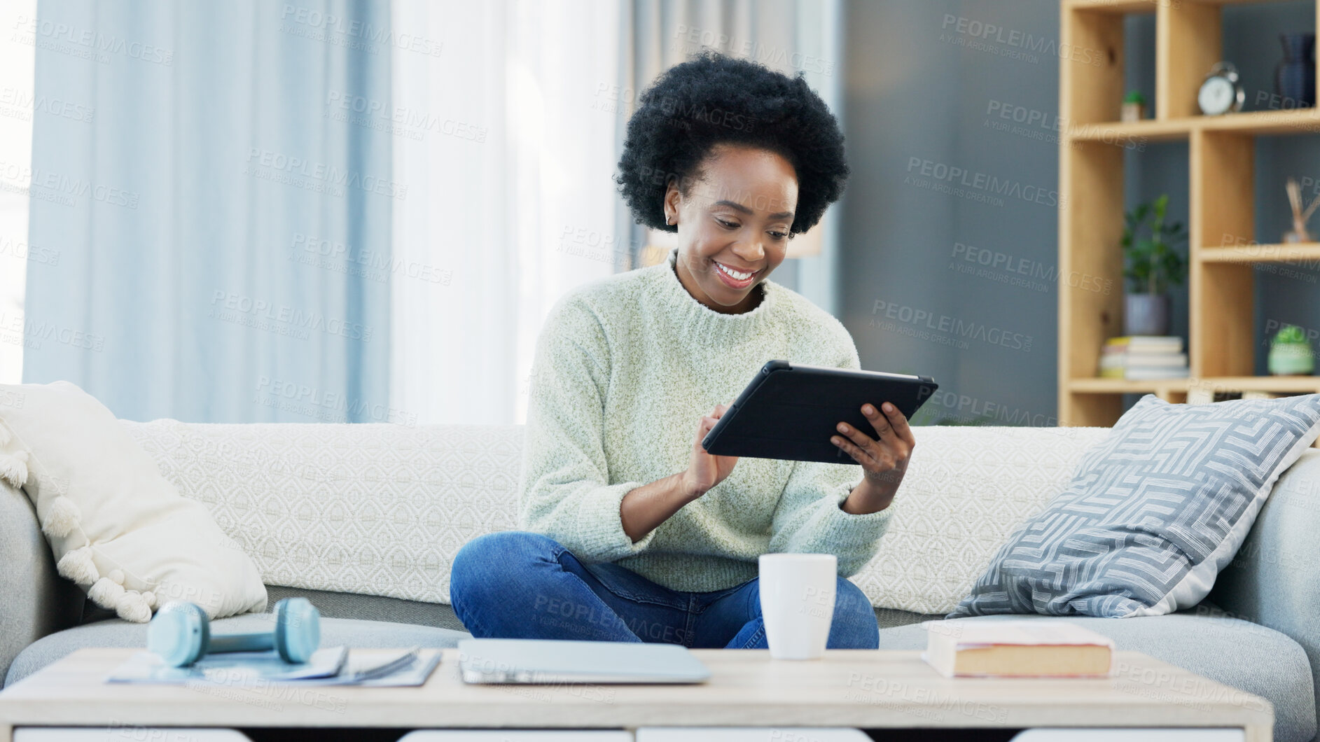 Buy stock photo Tablet, smile and black woman relaxing on a sofa networking on social media, mobile app or the internet. Happy, digital technology and young African female person scroll on website in the living room