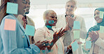 Meeting, planning and sticky notes on glass in the office with a diversity business team planning strategy. Teamwork, collaboration and coaching with a black woman leader teaching her staff at work