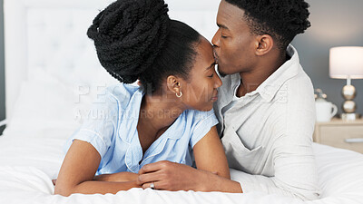 Love, support and trust between black couple sharing a special bond and communication while spending time in the bedroom. Commitment, marriage and understanding with man kissing head of woman