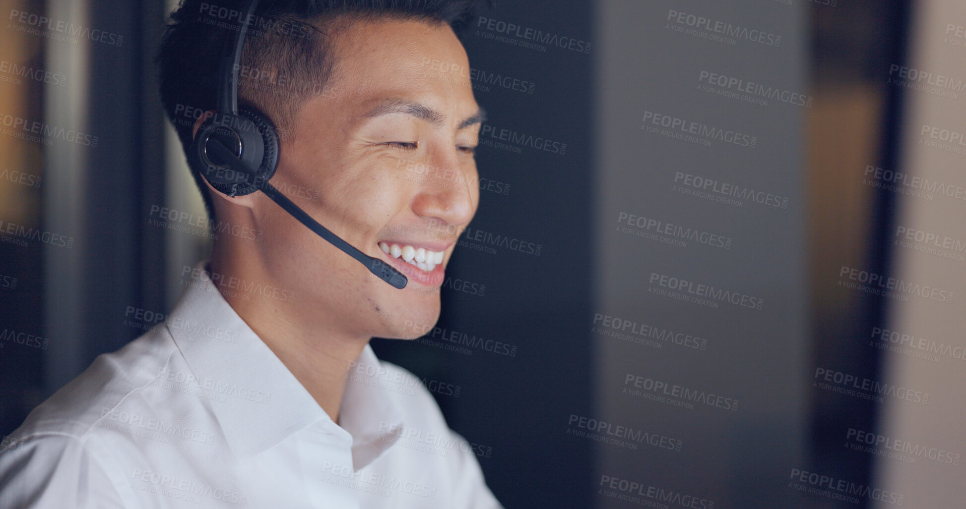 Buy stock photo Call center agent, night and happy face of Asian man with consulting, advice and headset in communication in office. Telemarketing, customer service or crm, help desk consultant for late support work