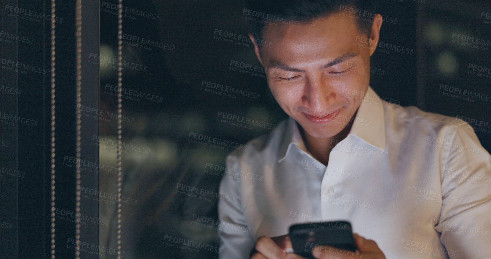 Buy stock photo Smartphone, night and Asian man with business, typing and connection with digital app, post and social media. Japanese person, worker and employee with a cellphone, communication and search internet