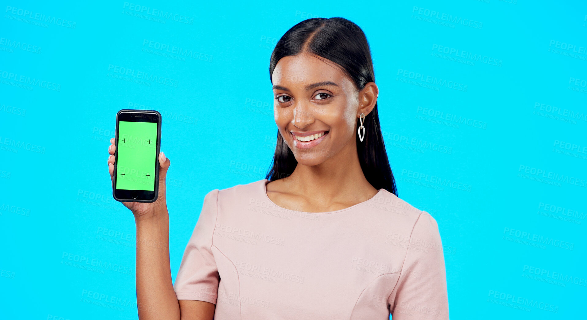 Buy stock photo Portrait, happy woman and green screen space of phone for advertising, contact or offer in studio on blue background. Indian model, mobile newsletter and mockup of promotion, info or deal coming soon