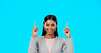 Face, employee and Indian woman with motivation, direction and happiness against a blue studio background. Portrait, female entrepreneur or lady with decision, inspiration or choice with joy or smile
