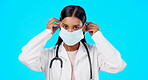 Studio woman, face mask and covid doctor, female surgeon or nurse for disease support, healthcare or pandemic help. Hospital policy compliance, safety portrait or medical person on blue background