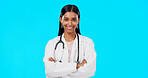 Studio woman, confidence and happy doctor, female surgeon or nurse for support, medical healthcare or health. Medicine professional pride, cardiology portrait and hospital person on blue background