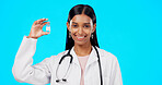 Studio woman, vaccine and happy doctor, female surgeon or nurse with covid 19, monkeypox or disease cure. Medical portrait, medicine bottle container or science hospital innovation on blue background