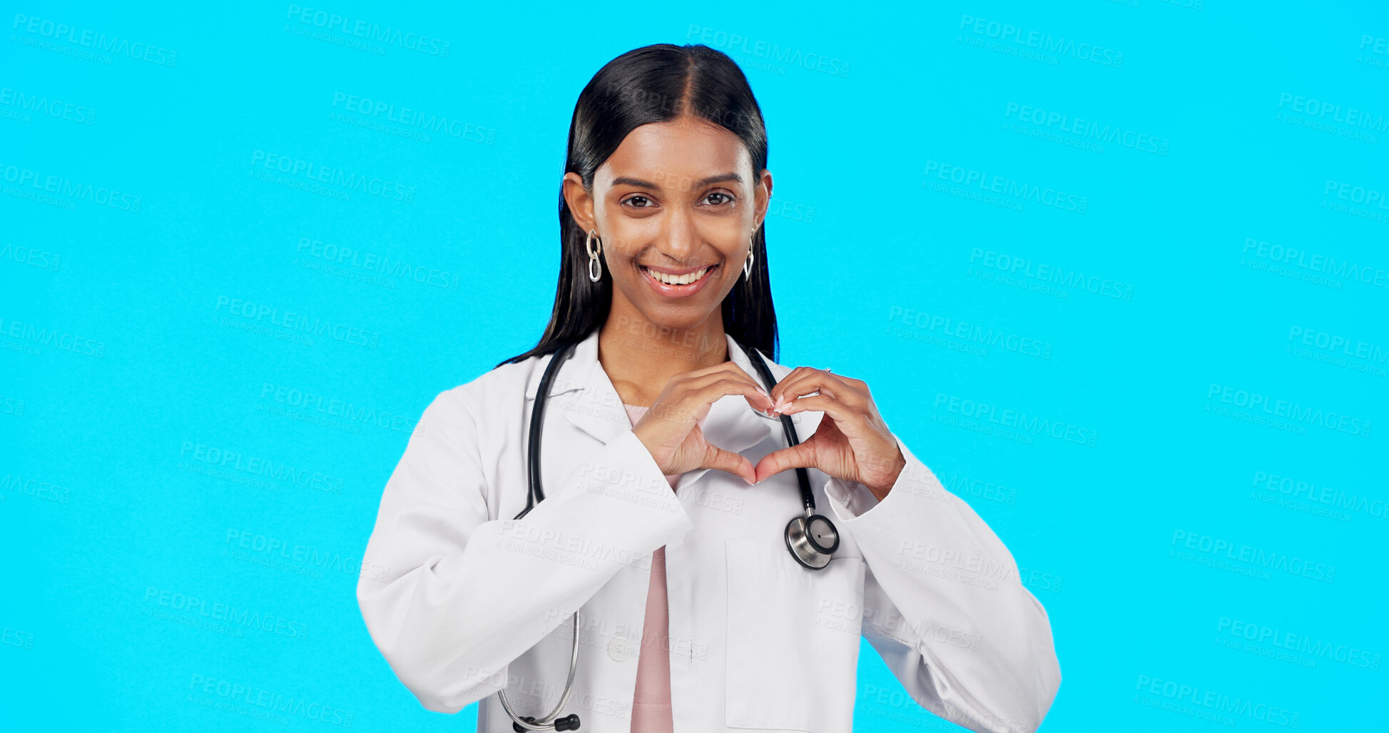 Buy stock photo Woman doctor, heart hand and face in studio, blue background and love emoji sign. Portrait, cardiology person and smile from healthcare and wellness with hope and happy with career trust or job