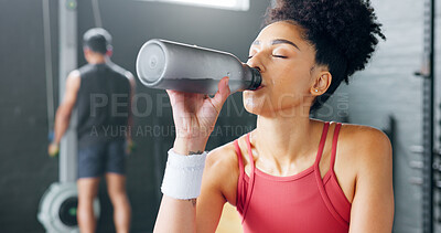 Buy stock photo Woman, fitness and drinking water in relax at gym after workout, training or indoor exercise. Active or sporty female person with mineral drink on break for diet, natural nutrition or sustainability