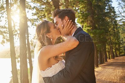 Buy stock photo Wedding, love and couple and kiss in park, forest and nature for celebration of union, care and marriage. Bride, groom and kissing in garden for romance, intimate bridal event or celebrate commitment