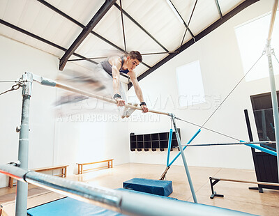 Buy stock photo Gymnastics, man and sports with a gymnast swinging on a horizontal bar inside of a gym for fitness, training and workout. Sport, exercise and practice with an athlete holding onto parallel bars