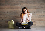 University, portrait of happy woman on floor with books on mockup space and education at college. Information, knowledge and backpack, student sitting on wall background with smile and book to study.