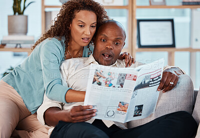 Buy stock photo Shock, newspaper and couple reading in their home while relaxing in the living room on a sofa. Surprise, shocked and mature man and woman with a newsletter while sitting together in their apartment