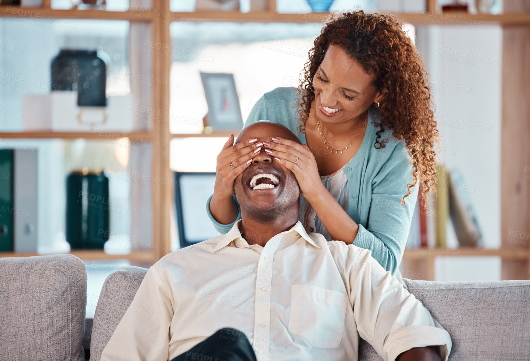 Buy stock photo Surprise, woman and cover eyes of man in living room for happiness, love and care together. Happy couple, playful relationship and hide for excitement, smile and laughing in romantic marriage at home