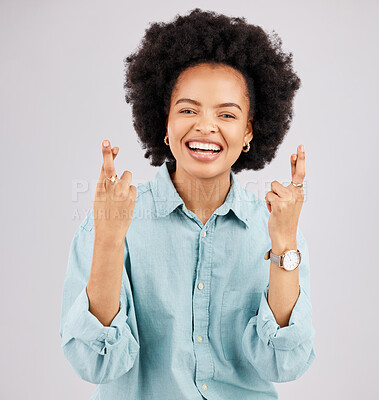 Buy stock photo Luck, woman portrait and fingers crossed with hope and smile in a studio with happiness. Isolated, gray background and young female model with hopeful and emoji hand sign laughing and waiting for win